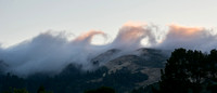 Waves of Fog crashing over Windy Hill at Sunset